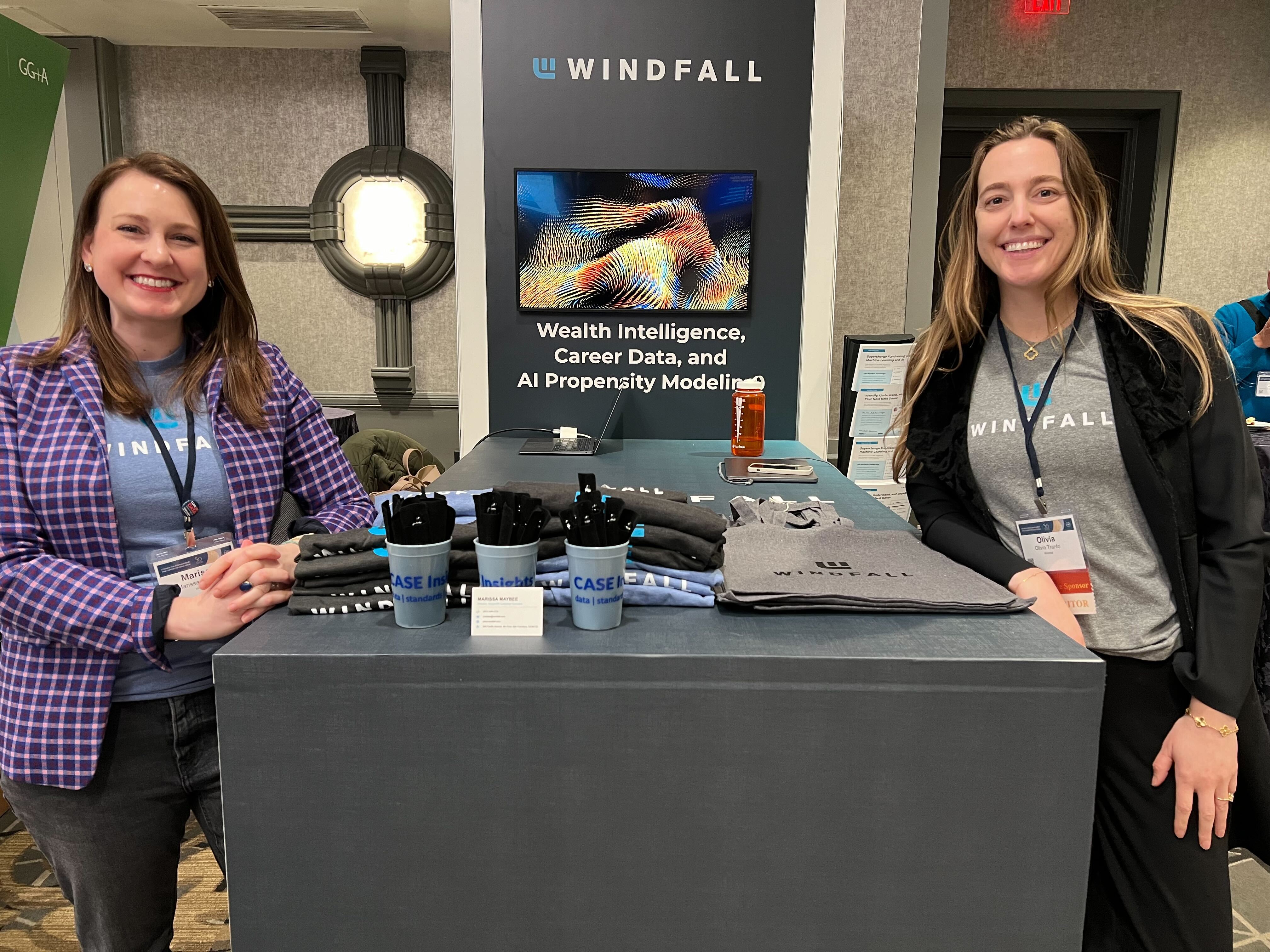 Employees in front of a Windfall booth at conference